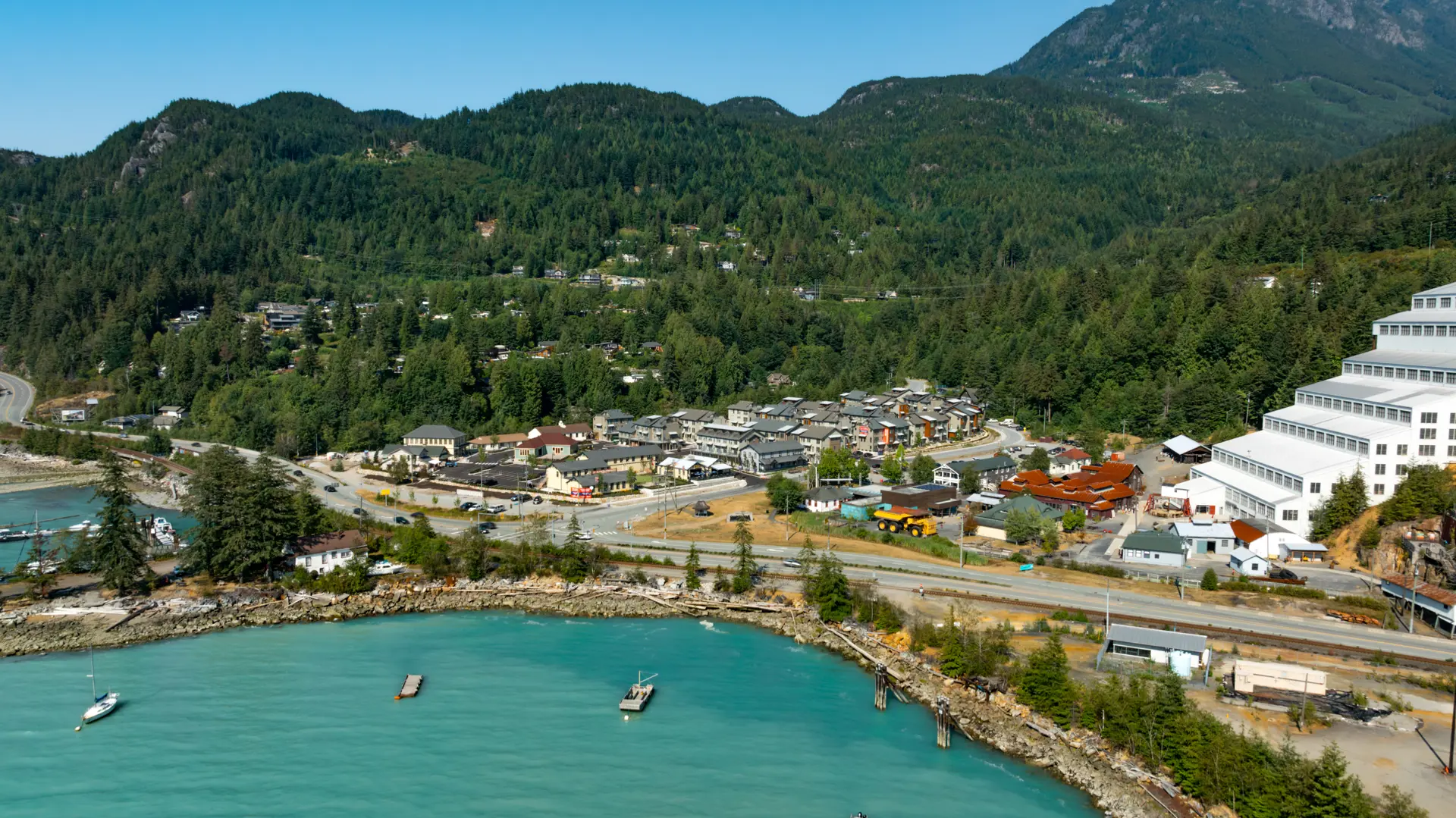 View of Britannia Beach with mountains in the background, Howe Sound waters, and the iconic Britannia Mine Museum