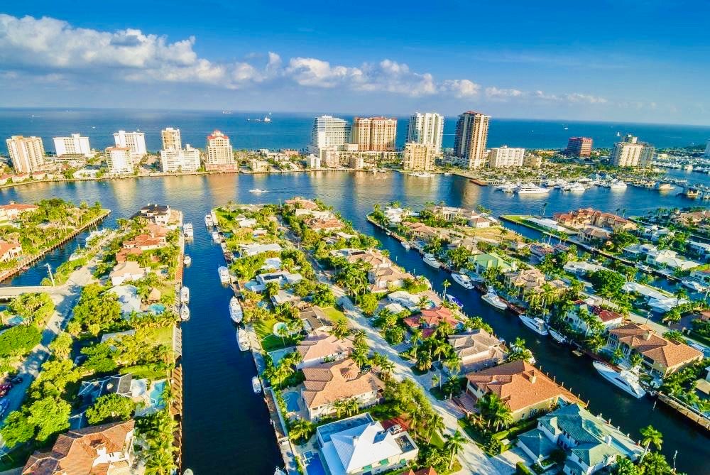 Scenic waterfront of Fort Lauderdale with boats, palm trees, and luxury homes