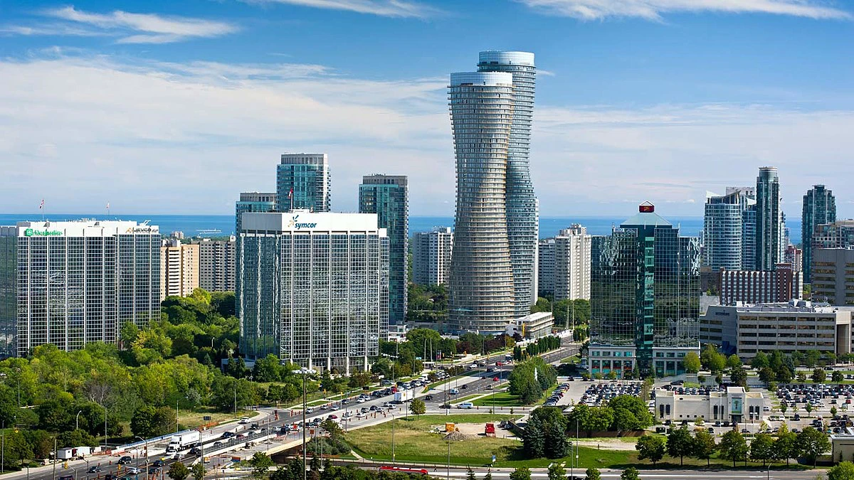 Modern skyline of Mississauga with waterfront views, tall buildings, and urban green spaces.