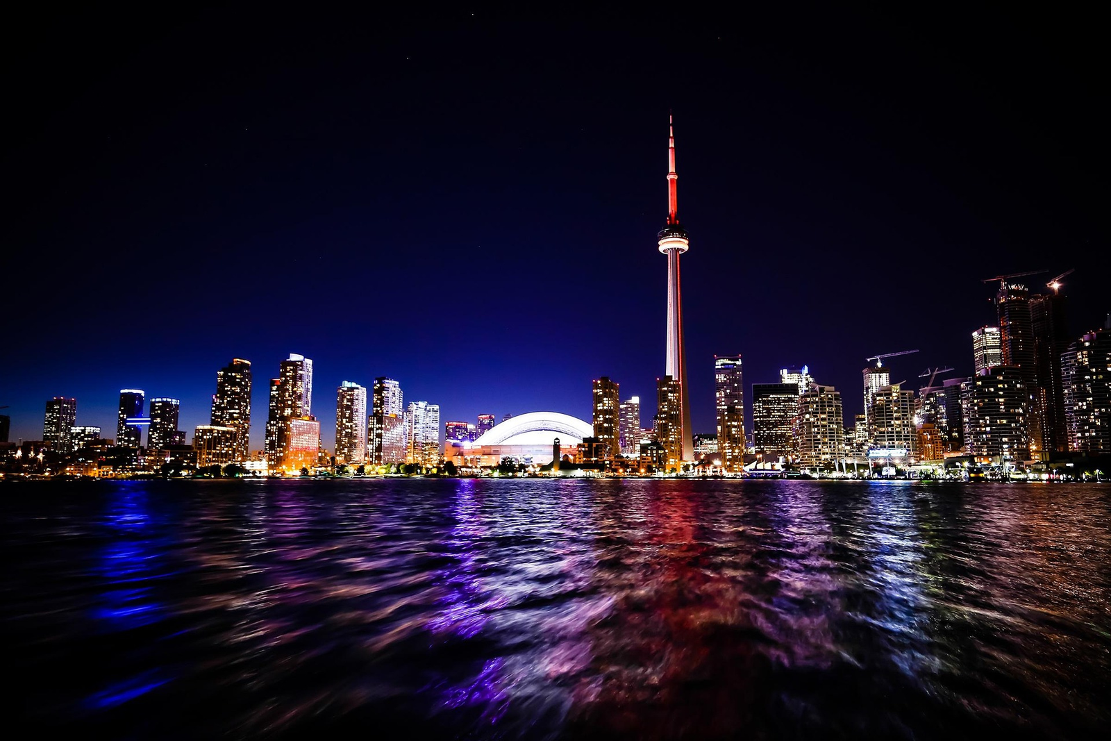 Aerial view of Toronto skyline with CN Tower and Lake Ontario at sunset