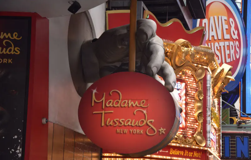 Madame Tussauds New York exterior and Times Square surroundings with vibrant cityscape cinematic daylight and iconic New York atmosphere