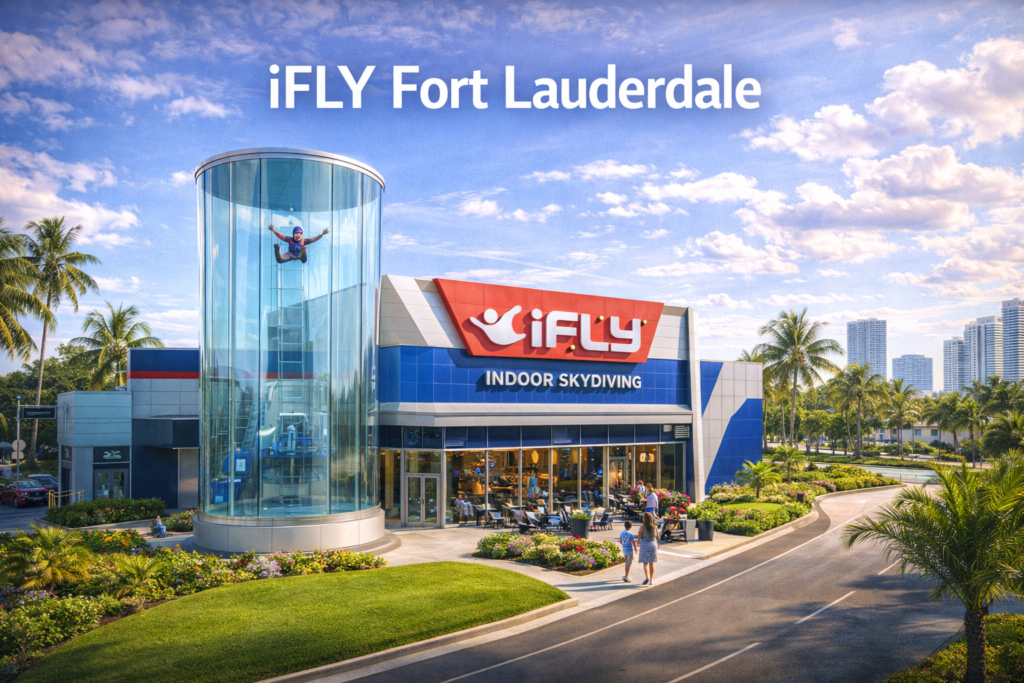 iFLY Fort Lauderdale indoor skydiving center with glass wind tunnel and flyer in action under bright Florida sky